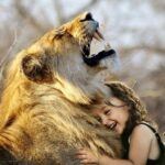 Girl hugging roaring lion