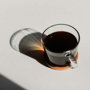 Cup of black coffee on white background