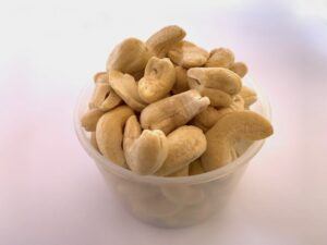 Measuring cup full of cashew nuts