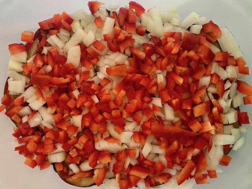 Finely chopped red pepper on vegan eggplant recipe