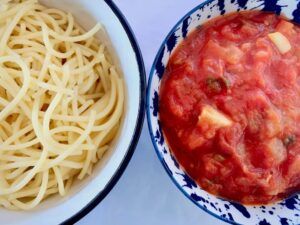 Bowl of spaghetti & bowl of tomato sauce