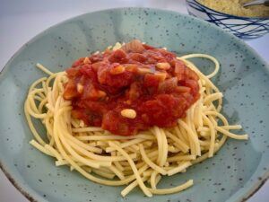 Spaghetti with tomato sauce with pine kernals