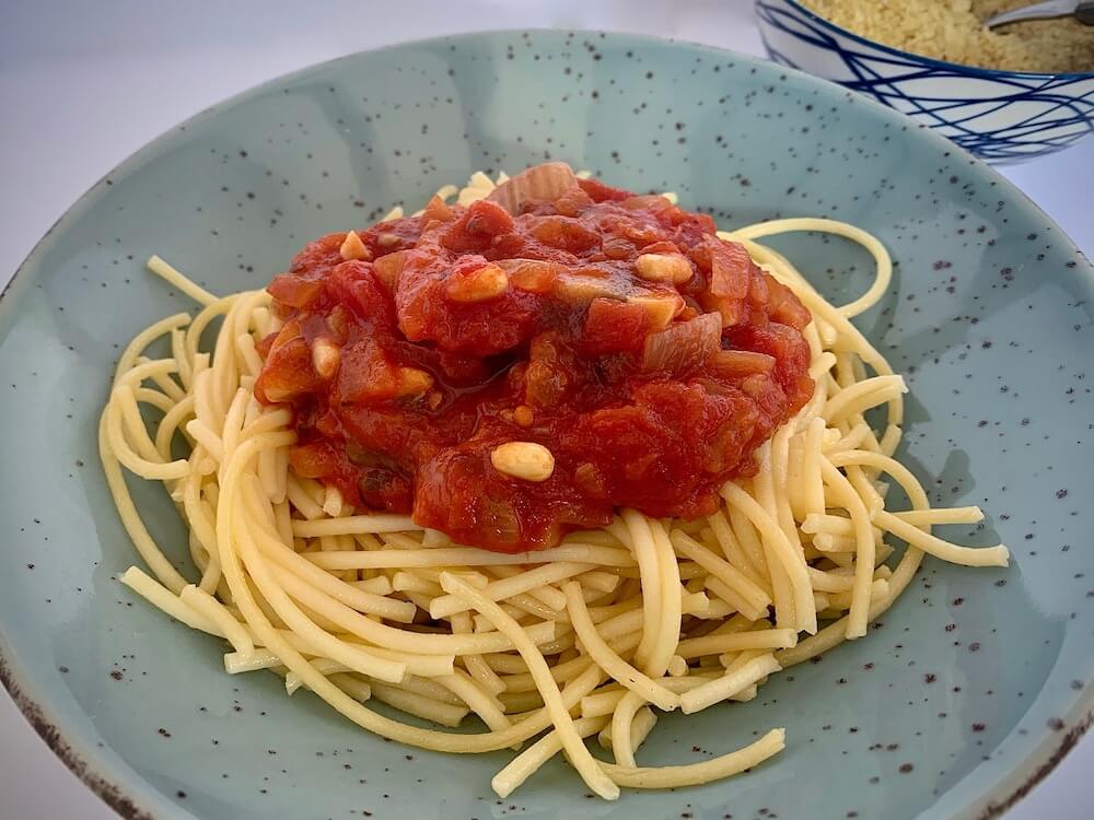 Spaghetti with tomato sauce with pine kernals