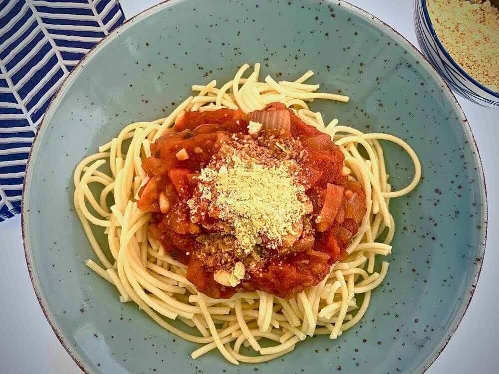 Vegan parmesan on pasta pomodoro