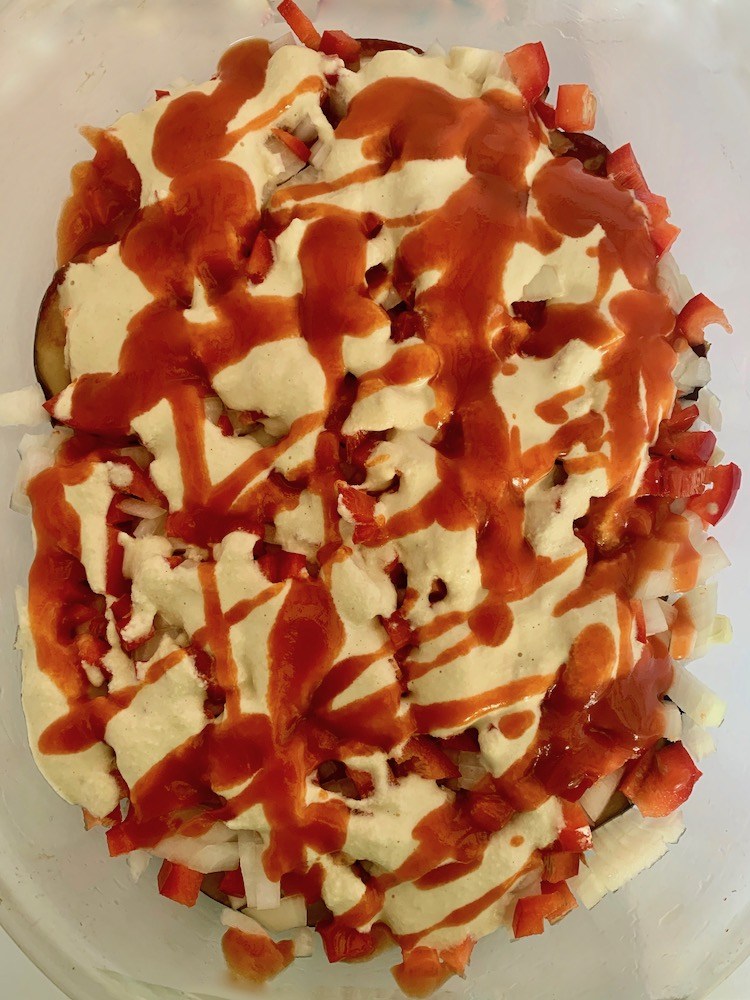 Tomato frito and cashew sauce on top of casserole dish