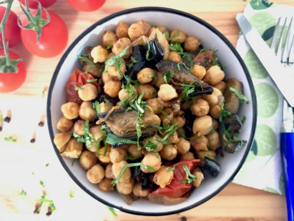 Bowl of roasted chickpeas with eggplant and cherry tomatoes