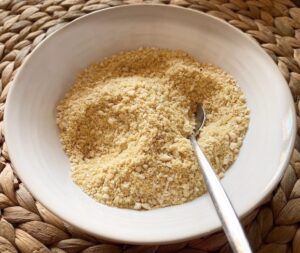 Homemade vegan parmesan cheese in a white bowl