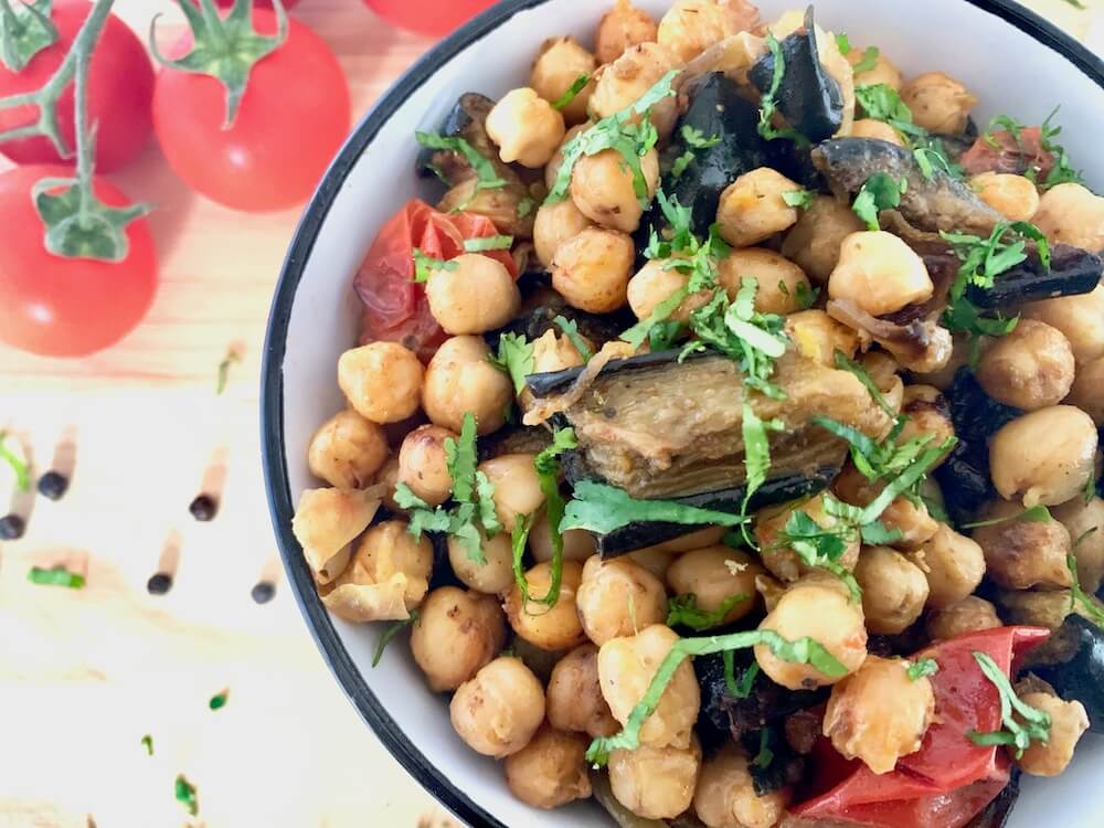Bowl of roasted chickpeas with eggplant and cherry tomatoes