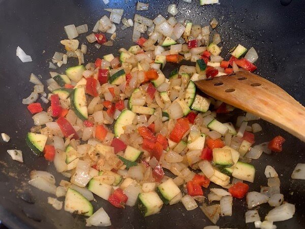 Frying onions, red pepper and mushroom for vegan chilli beans