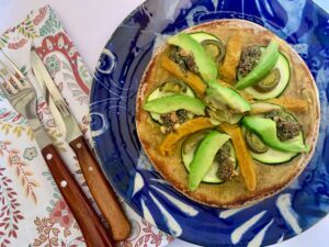 Gluten free vegan pizza with avocado on top