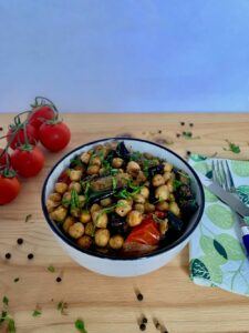 Bowl of roasted chickpeas with eggplant and cherry tomatoes