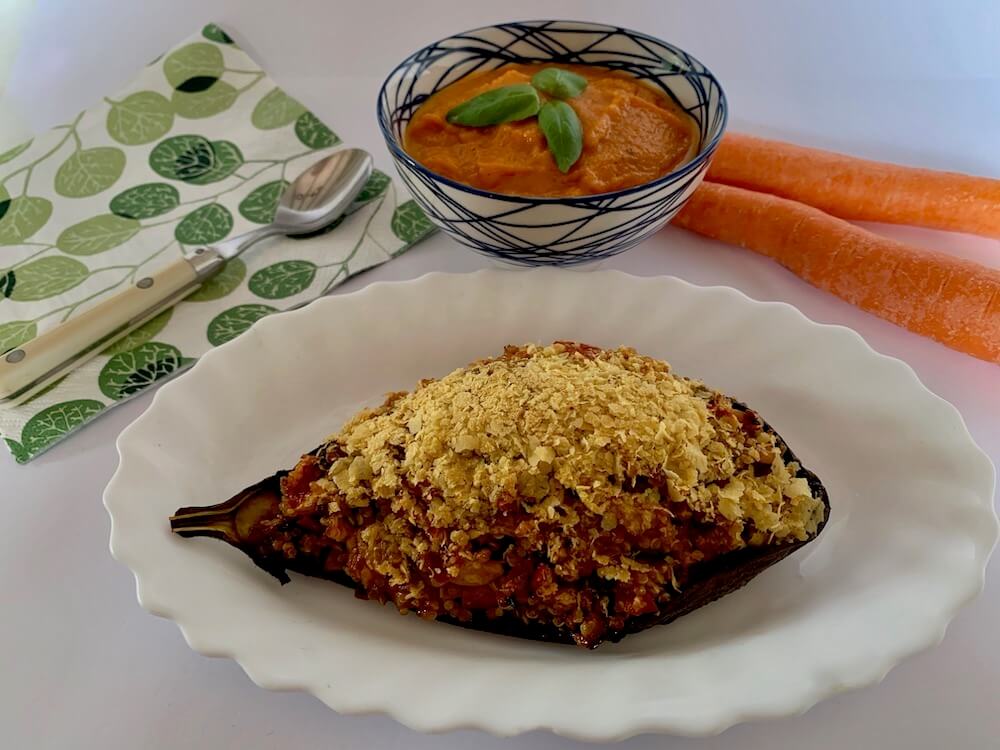 Stuffed eggplant served with quinoa and carrot sauce