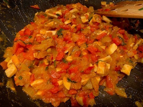 Onion, eggplant, mushroom, red pepper and tomato in a pan. Filling for stuffing eggplants.