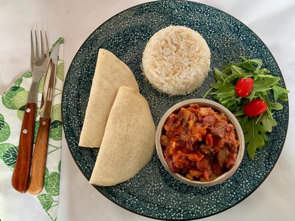 Plate with rice, GF wraps and a bowl of vegan chilli beans