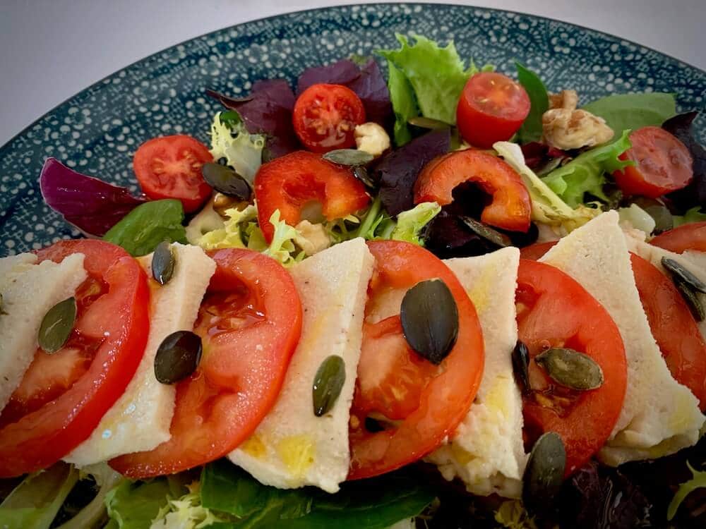 Close up of vegan mozzarella & tomato salad