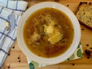 Bowl of vegan french onion soup with nutritional yeast on top
