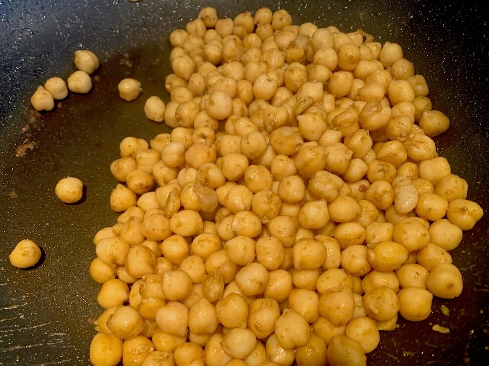 Chick peas frying in cumin and chilli