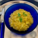 Yellow lentil dahl in a blue bowl