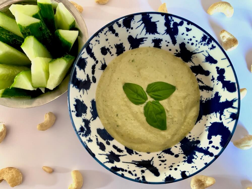 Bowl of vegan cashew sauce with basil & garlic