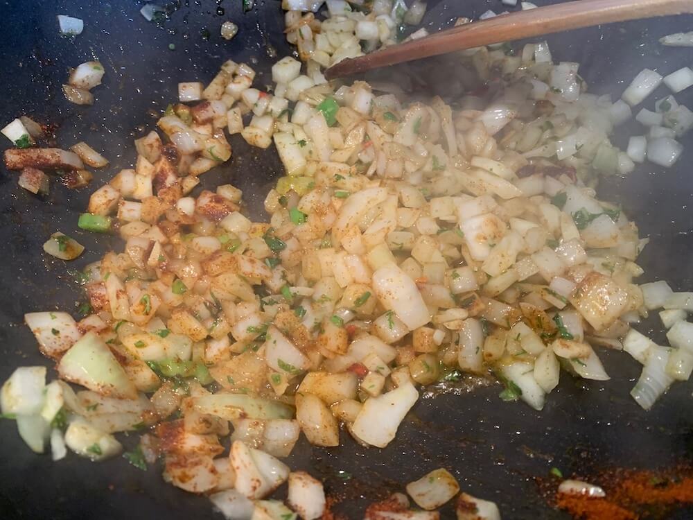 frying onions & garlic with herbs & spices