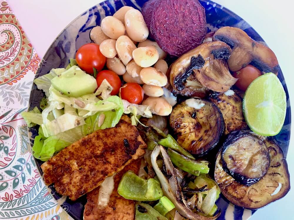 Grilled veggie platter with eggplant, beetroot, mushrooms, green pepper, onion, tofu, cherry tomatoes, beans & salad