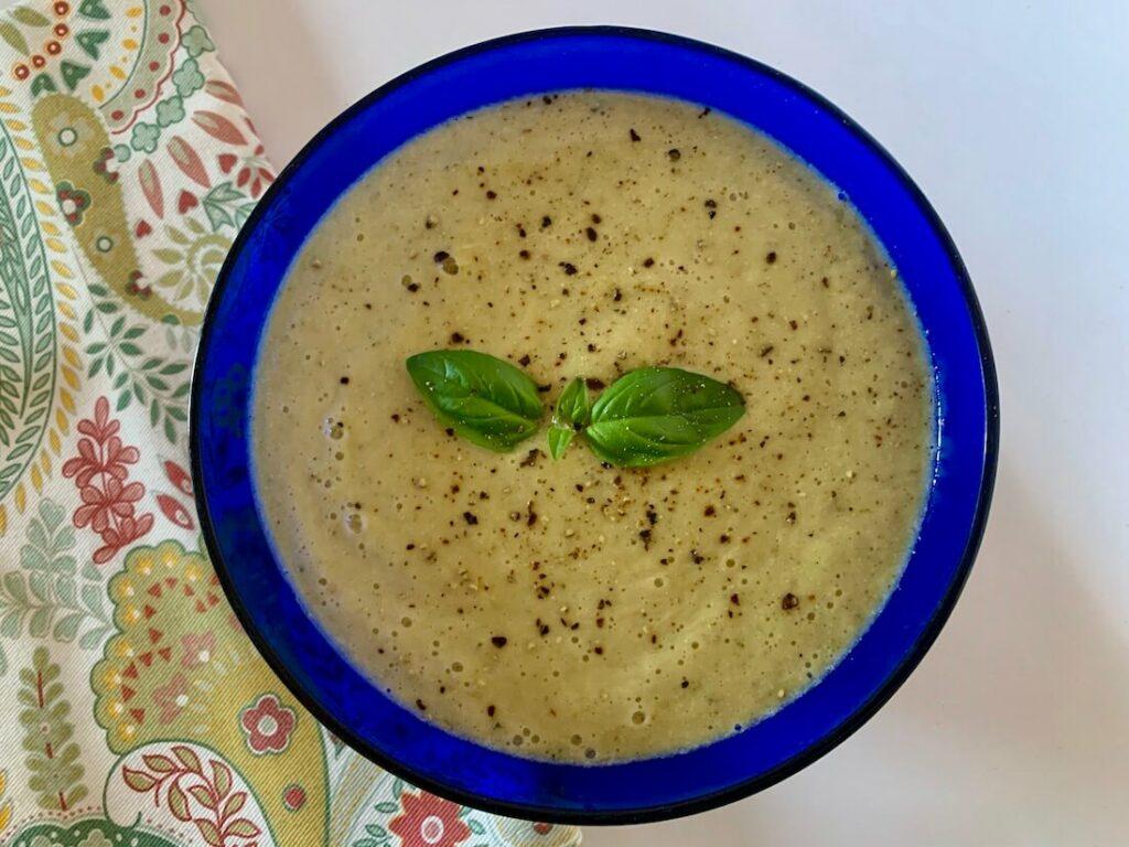 Blue bowl full of oil free zucchini soup