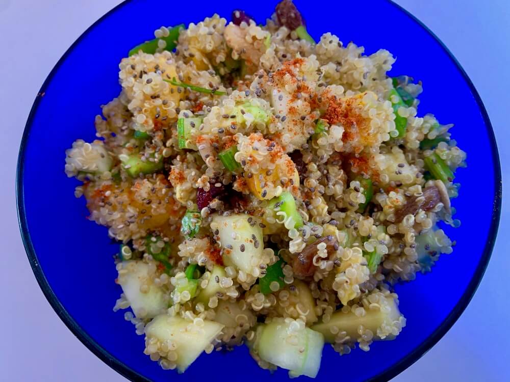 Blue bowl full of quinoa salad