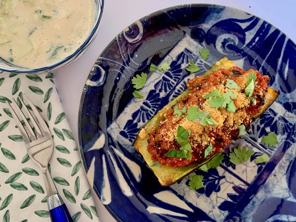 Vegan stuffed zucchini boat with vegan raita sauce