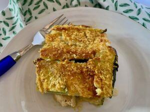 Slice of zucchini casserole on a white plate