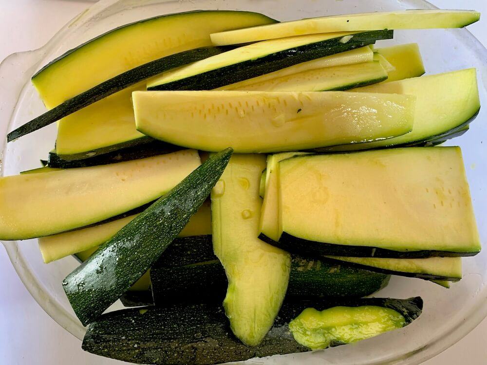 Thinly sliced zucchini in olive oil and garlic marinade