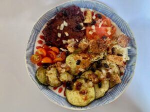 Black bean burger with tomato & grilled zucchini, eggplant, onion & tofu