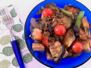 Blue bowl of grilled summer vegetable salad