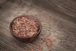 Bowl of flax seed on wooden table