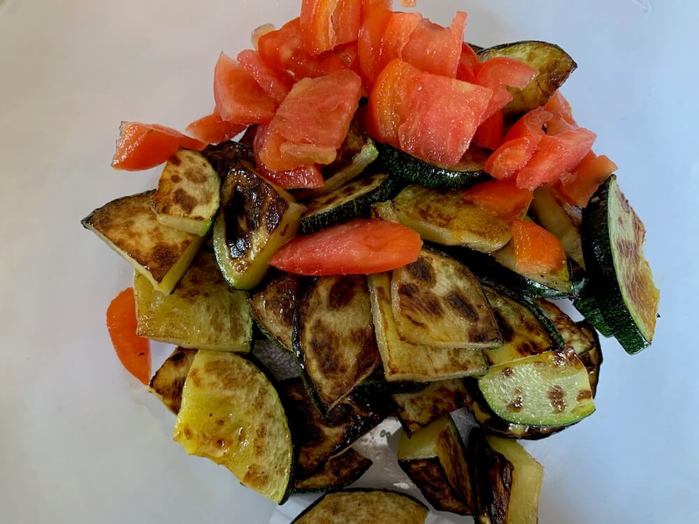 Grilled zucchini slices with raw tomato