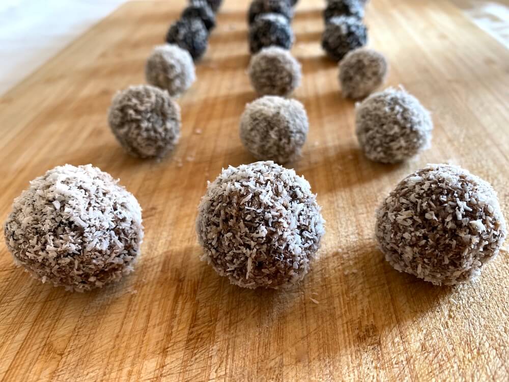 Protein energy balls on a chopping boards