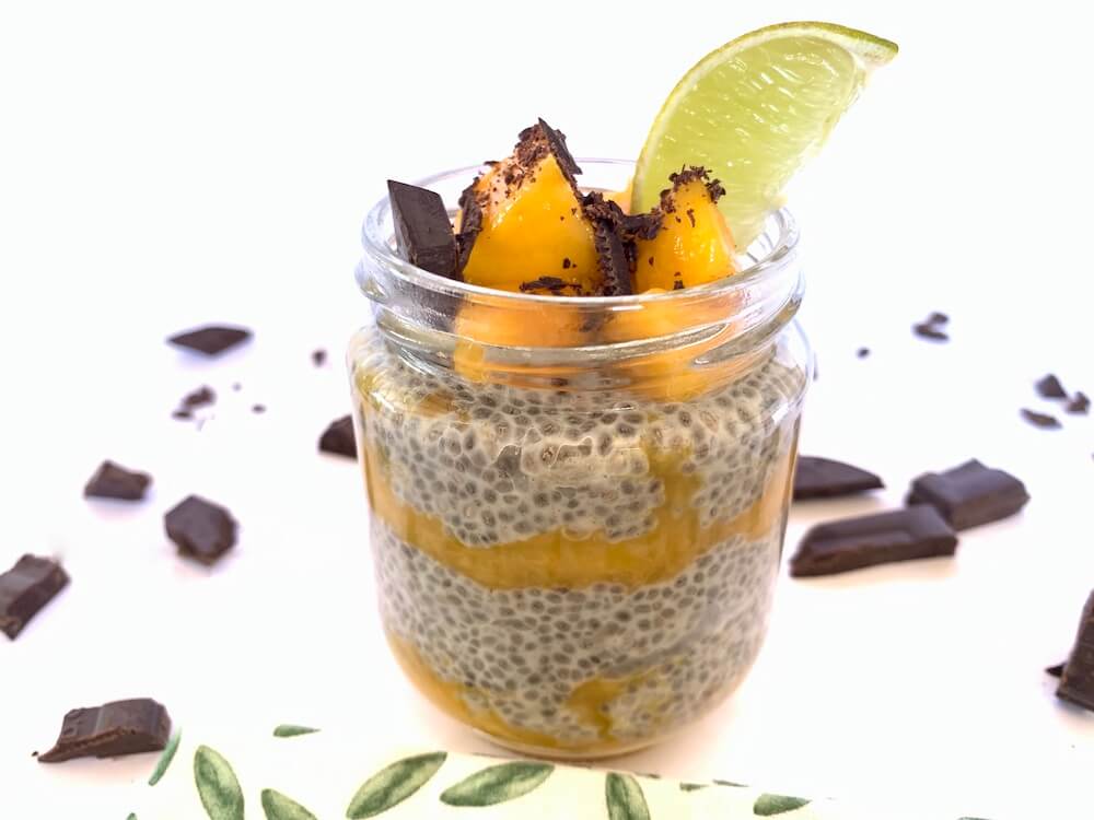 Jar of chia seed pudding with mango, dark chocolate and lime