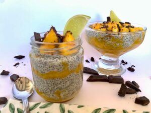 Two dessert bowls filled with chia seed pudding with mango and lime