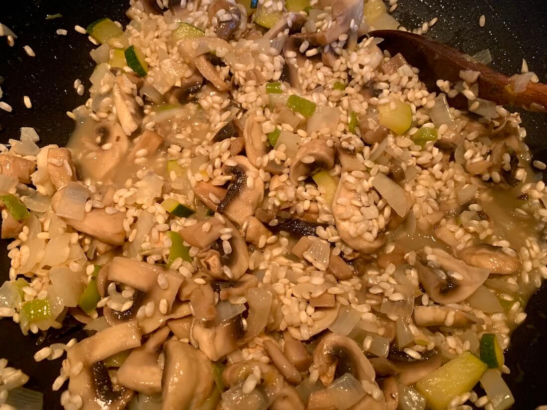 Liquid in the pan of rice and mushrooms