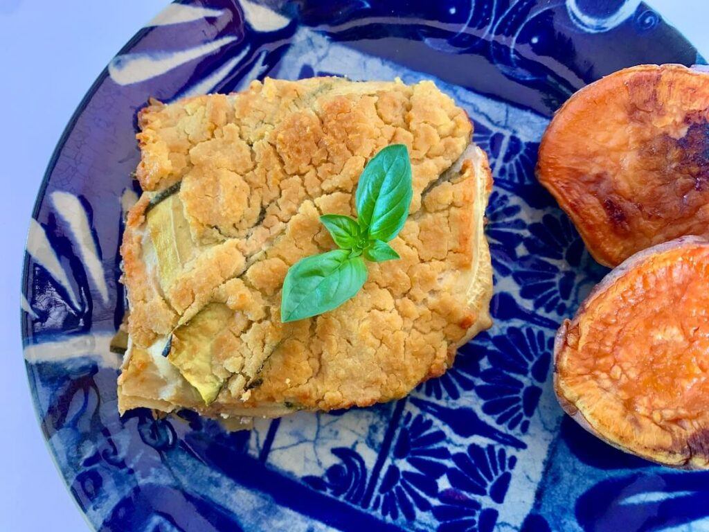 View from above, of a slice of zucchini lasagna with sweet potato on the side. Gluten free, oil free, pasta free.