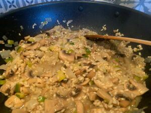 Liquid in the pan of rice and mushrooms
