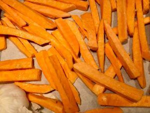 Roasting sweet potato chips and a bulb of garlic