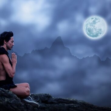 Man sitting meditating with mountains and the moon in the background
