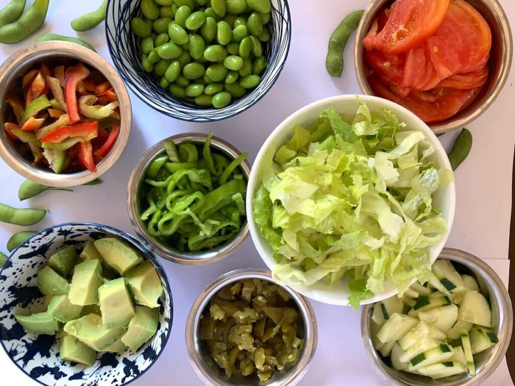 Salad ingredients in separate bowls