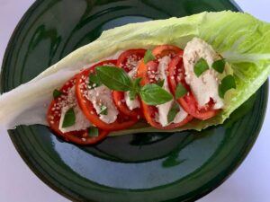 Vegan Caprese salad served on a lettuce leaf