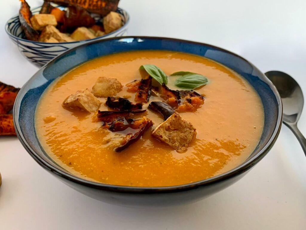 Bowl of roasted pumpkin soup with tofu croutons on top