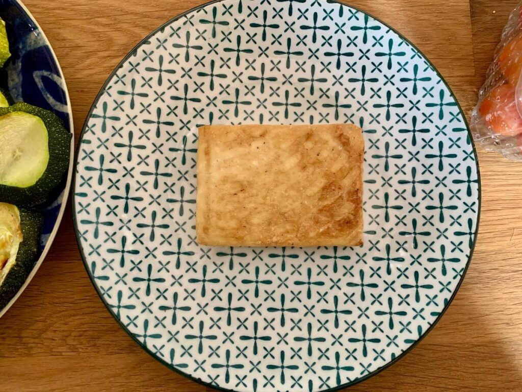 Slab of tofu for eating as a burger