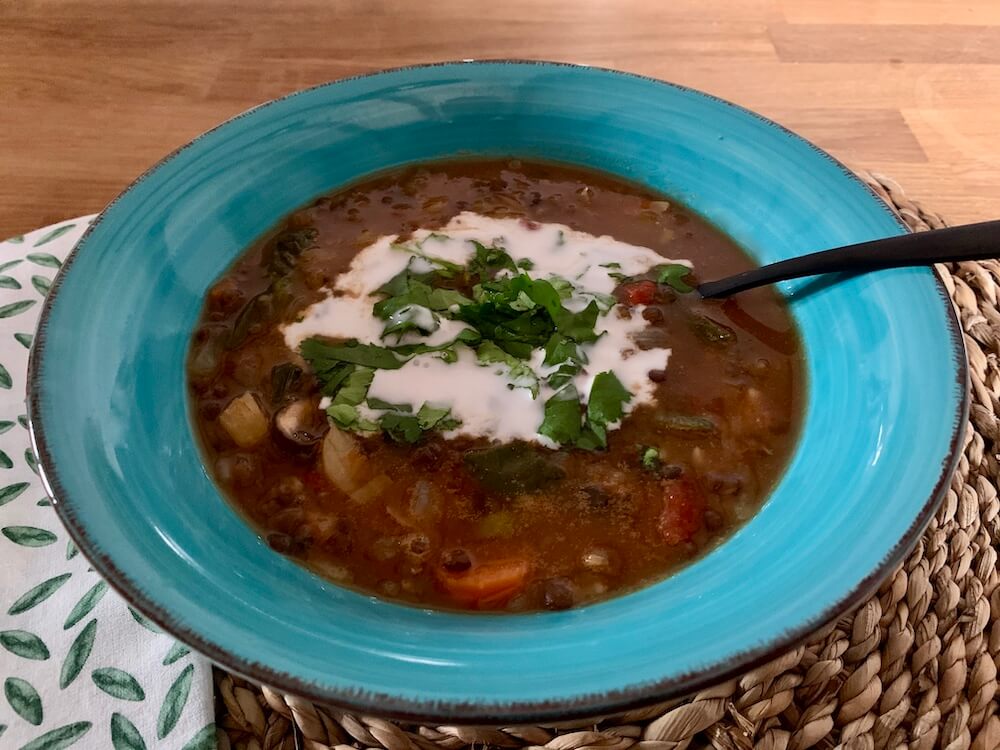 Vegan lentil soup with coriander and vegan cream