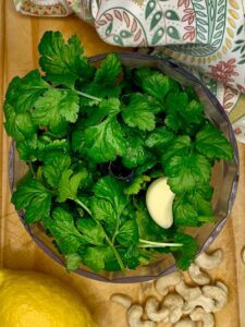 Fresh cilantro and a clove of garlic in the food processor
