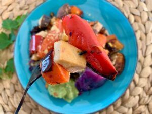 How to roast vegetables without oil. Red pepper, tofu and carrot on a fork