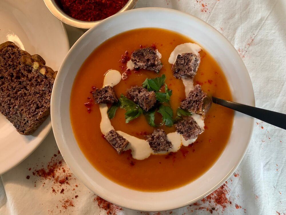 Roasted sweet potato & carrrot soup served with croutons and vegan cream
